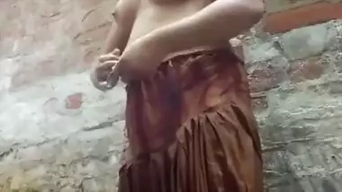 Village girl having open bath